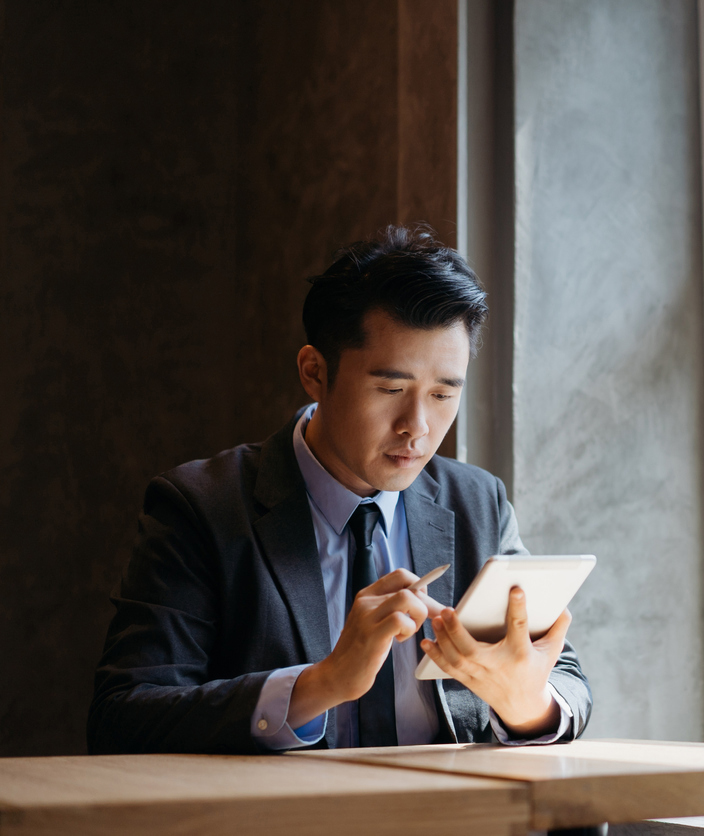 Young asian businessman working with digital tablet and stylus pen